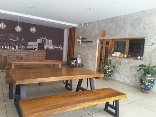 a dining room with wooden tables in a restaurant at Huglampang Boutique Hotel in Lampang