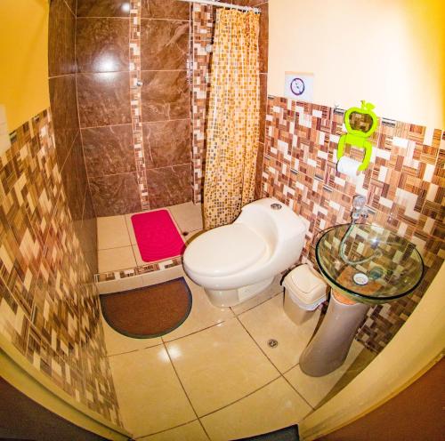 a bathroom with a toilet and a shower at BiosWild in Cusco