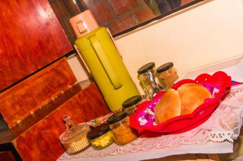 a table with a basket of bread and a thermos at BiosWild in Cusco