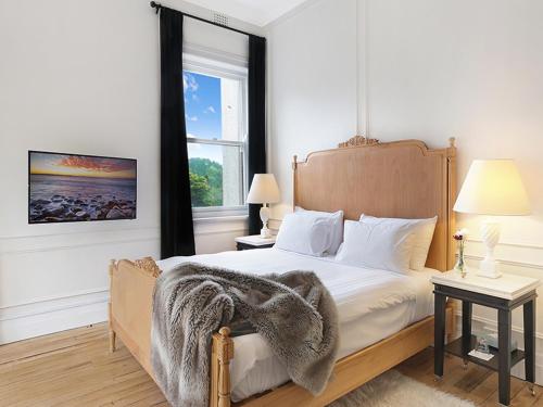 a bedroom with a bed with a blanket and a window at The Robertson Hotel in Robertson