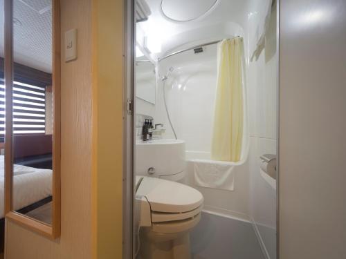 a small bathroom with a toilet and a sink at PACIFICO Hotel and Spa in Iwaki