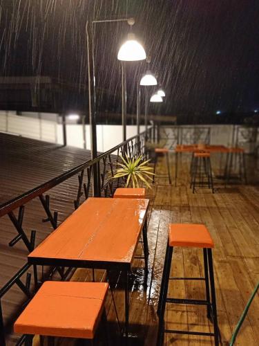 a row of tables and chairs in the rain at Huglampang Boutique Hotel in Lampang