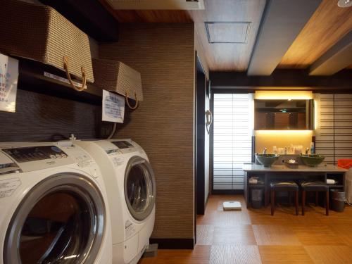 a laundry room with a washing machine and a kitchen at PACIFICO Hotel and Spa in Iwaki