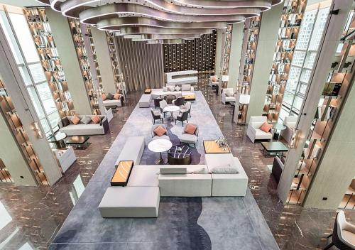a lobby with couches and tables in a building at Tianyuan Grand Hotel Xiamen in Xiamen
