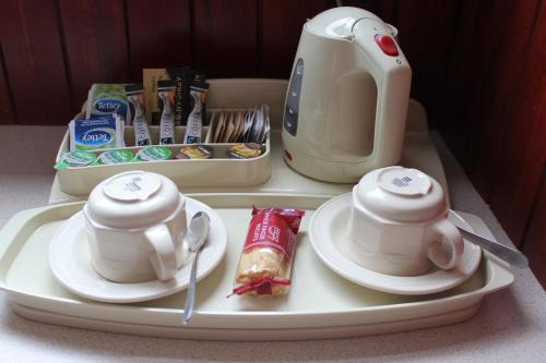 a tray with two cups and a tea set on it at Beeches Aberdeen in Aberdeen