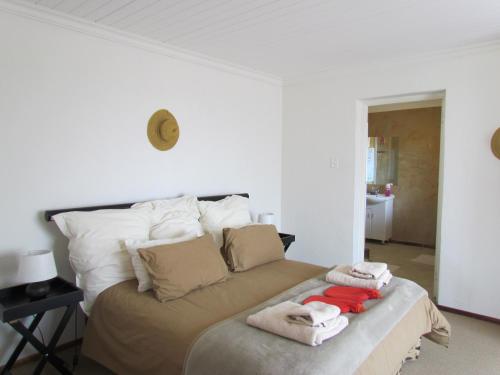 a bedroom with a bed with towels on it at Pumula Guest Farm in Fouriesburg