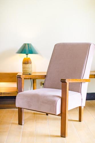 a chair sitting next to a desk with a lamp at The Park - Silang in Silang