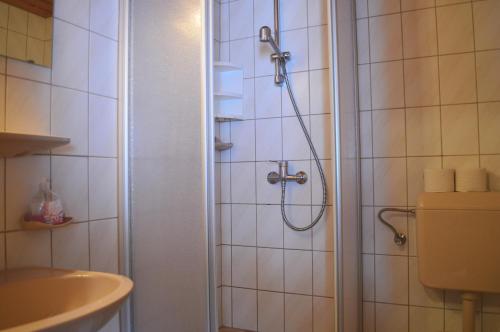 a bathroom with a shower and a sink at Pension Leitenhof in Niederau
