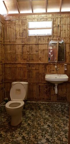 a bathroom with a toilet and a sink at Sunari Beach Resort 2 in Selayar