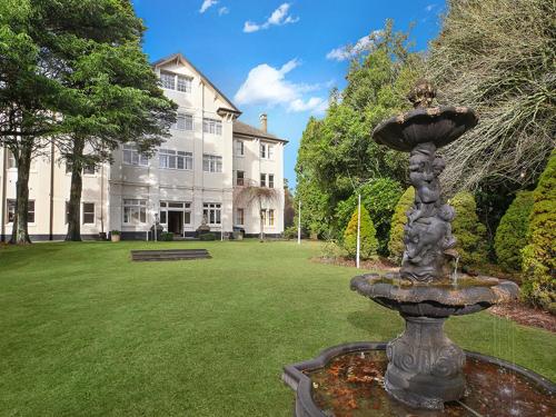 a large stone building with a fountain in the middle of it at The Robertson Hotel in Robertson