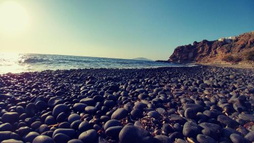 a large group of rocks on a beach at Amaranti House n Art in Mandrakion