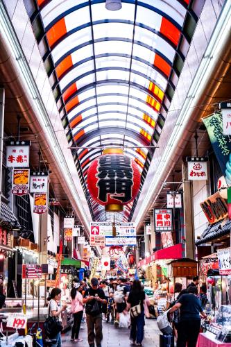 a crowd of people walking through a market at The Royal Park Canvas - Osaka Kitahama in Osaka