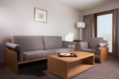 a living room with a couch and a coffee table at Seogwipo KAL Hotel in Seogwipo