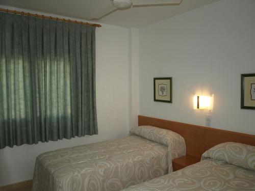Postel nebo postele na pokoji v ubytování Apartaments Geminis