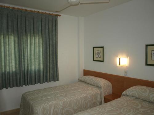 Katil atau katil-katil dalam bilik di Apartaments Geminis