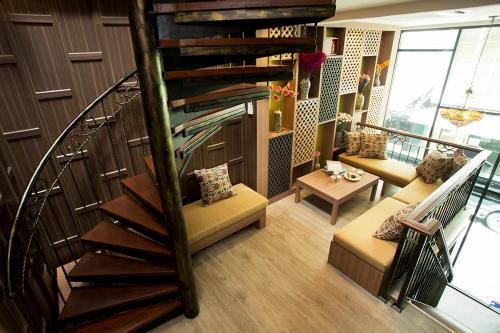 a living room with a spiral staircase in a building at GHEE GELATO HOUSE in Bangkok