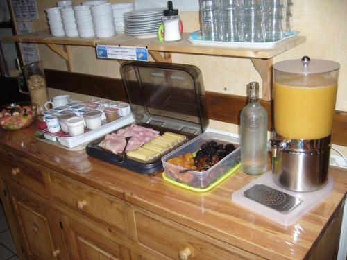 a tray of food sitting on a counter with a juice at HOTEL Auberge du grand Git in La Chaux Neuve