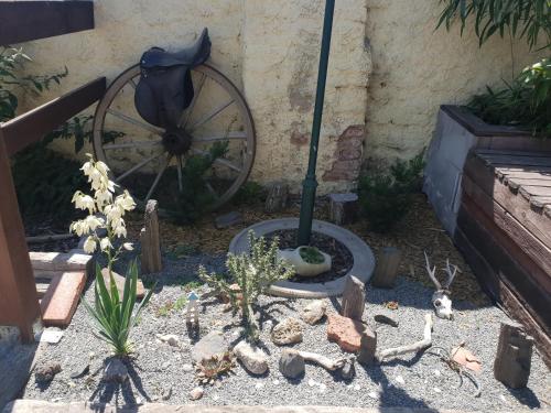 a garden with an umbrella and a wheel at Farm Stay NH Stables in Nýřany