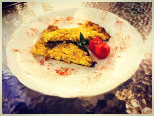a plate of food with tomatoes on a table at 4 Seasons in Vizitsa in Vizitsa