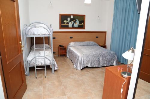 a bedroom with a bed and a bunk bed at Accord Le Rose in Palagiano