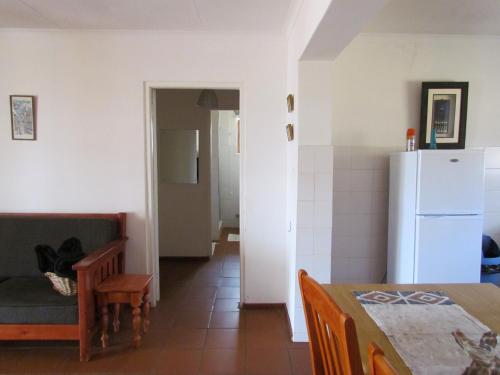 a kitchen and a dining room with a refrigerator at Pumula Guest Farm in Fouriesburg