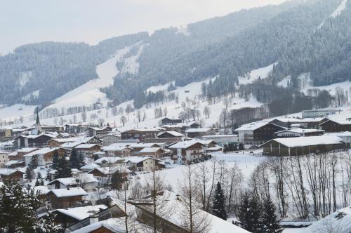 a town covered in snow on a mountain at Pension Leitenhof in Niederau