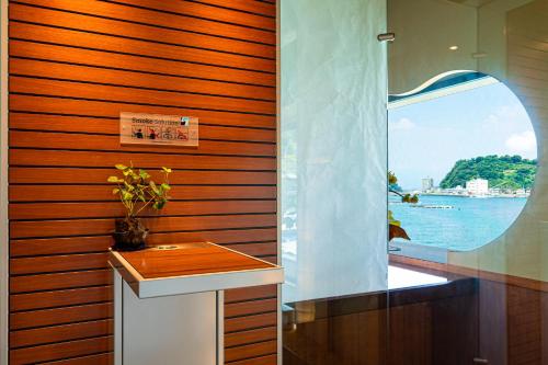 a bathroom with a sink and a window at Izu Mitohama Shotokan in Numazu