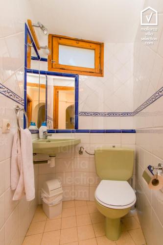 a bathroom with a toilet and a sink and a mirror at E256 Citadini 39 by Mallorca Villa Selection in Alcudia