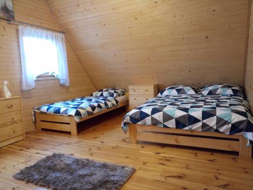 Postel nebo postele na pokoji v ubytování Domek letniskowy Zacisze