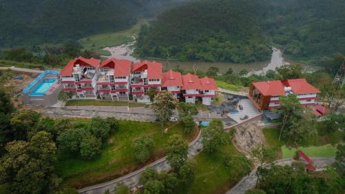 an aerial view of a resort with a river at The Lake View Munnar in Munnar