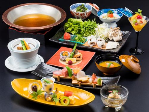 a table with plates of food and bowls of soup at Izu Mitohama Shotokan in Numazu