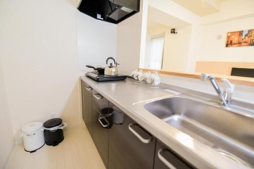 a kitchen with a sink and a counter top at momo premium 401 in Sapporo