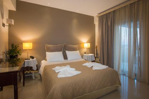a hotel room with a bed with towels on it at Dali in Zakynthos