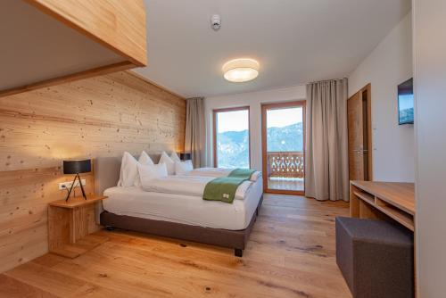 a bedroom with a bed and a large window at Skylodge Alpine Homes in Haus im Ennstal