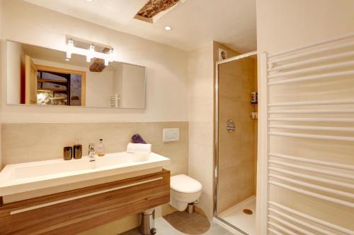 a bathroom with a sink and a shower at Heart Of Valbonne in Valbonne
