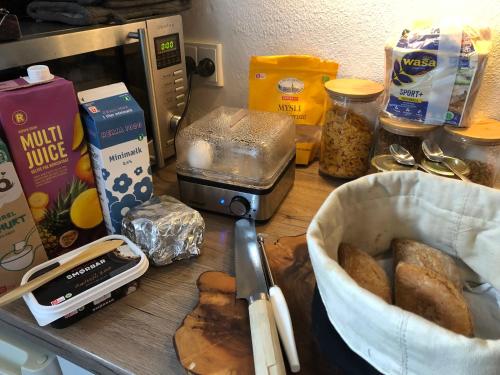 a counter with bread and other food items on it at Helts B&B - Helts Guesthouse in Herning