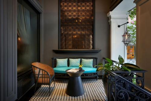 a patio with a table and chairs on a balcony at La Siesta Premium Hang Be in Hanoi