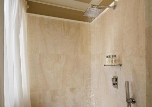 a bathroom with a shower with a shower curtain at Brunelleschi Hotel in Florence
