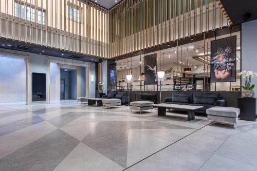 a lobby with couches and tables in a building at Radisson Blu Hotel Prague in Prague