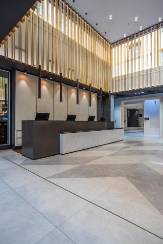 a lobby with a large chandelier in a building at Radisson Blu Hotel Prague in Prague