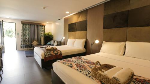 a hotel room with two beds and a room with at Treetop Suites in Coron