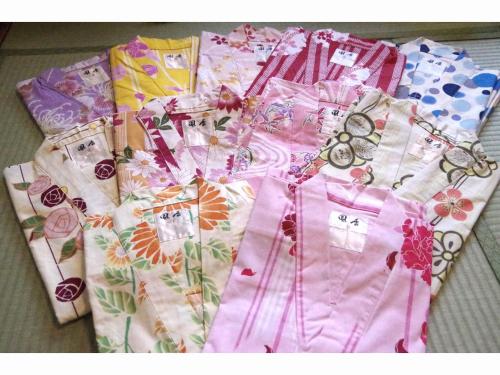 a pile of pink shirts sitting on the ground at Ryoso Chatani in Kyoto