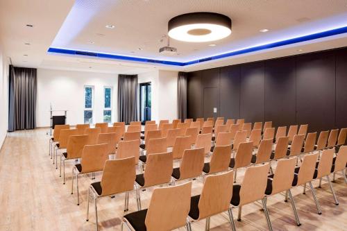 a lecture hall with chairs and a podium at Friendly Cityhotel Oktopus in Siegburg