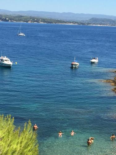 people swimming in a large body of water with boats at Logis centre historique 4 personnes - Soleil Levant La Ciotat in La Ciotat