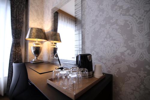 a desk with a lamp and glasses on it at SHINJUKU GLOBAL HOTEL in Tokyo