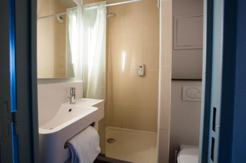 a bathroom with a sink and a toilet at B&B HOTEL Valenciennes Marly in Marly