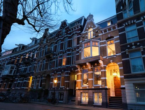 a large brick building on a city street at City B&B Villa Nicola in Amsterdam