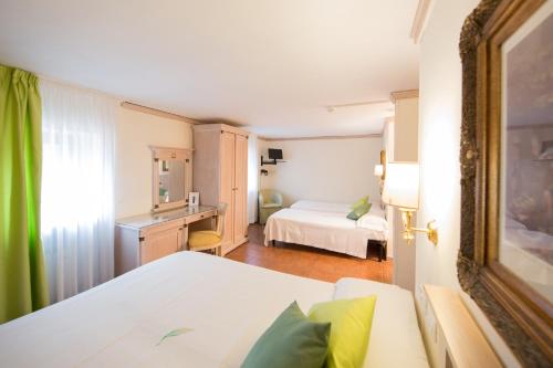 una camera d'albergo con letto e scrivania di Mancini Park Hotel a Mostacciano