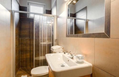 a bathroom with a sink and a toilet and a mirror at Pension Walchauhof in Flachau