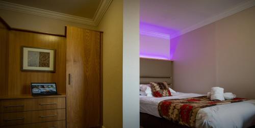 a hotel room with a bed and a purple ceiling at Crown Spa Hotel Scarborough by Compass Hospitality in Scarborough